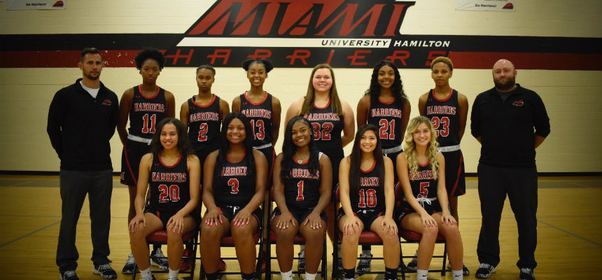 2018-19 Women's Basketball Team standing on the basketball court in 2 lines